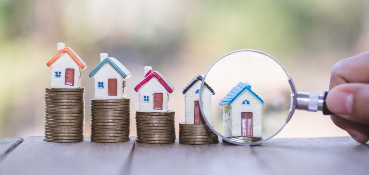 House searching concept with a magnifying glass, house and money. magnifying glass and coins. concept of mortgage, construction, rental housing.